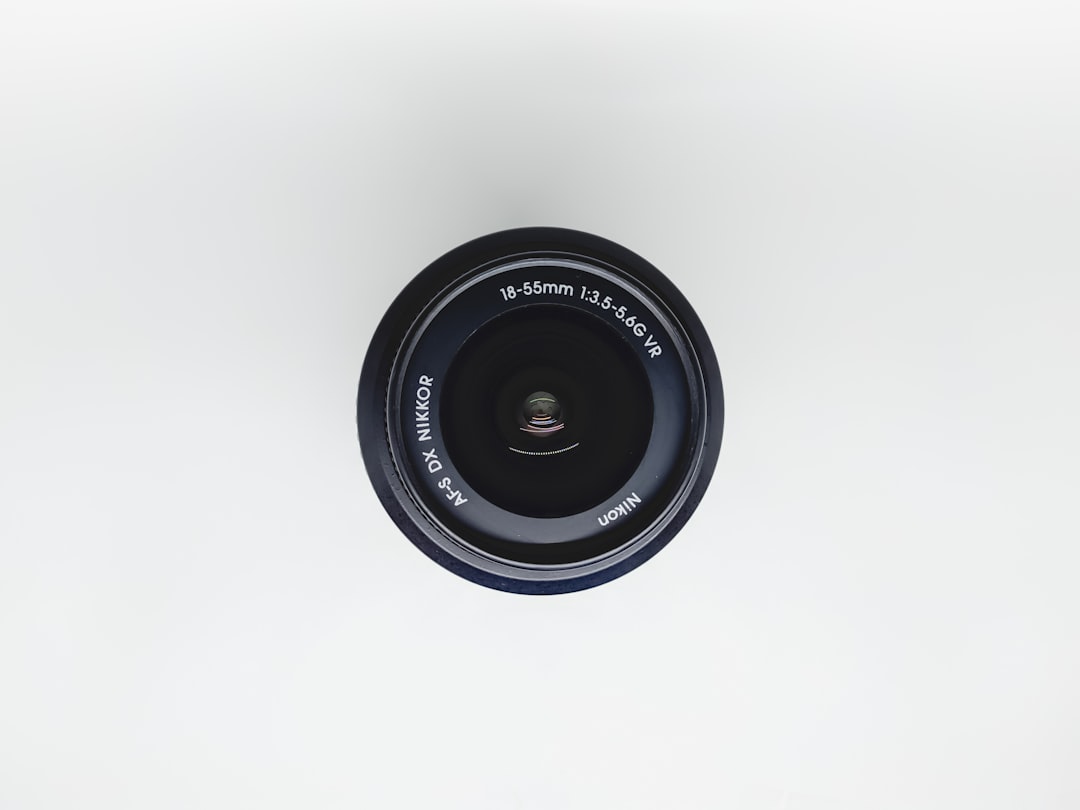 A Nikon camera lens, model AF-S DX NIKKOR 18-55mm 1:3.5-5.6G VR, viewed from above against a plain white background.