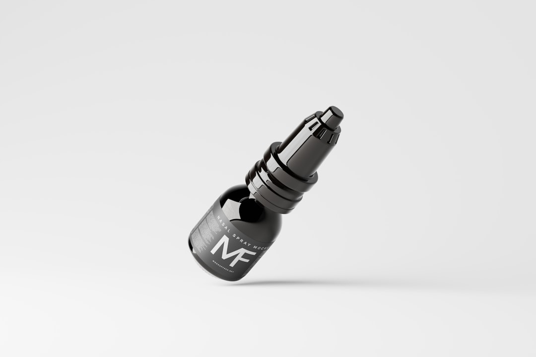 A small black dropper bottle labeled “MF” is floating against a plain white background, angled slightly upward. The design appears minimalistic and modern.